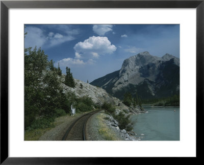 Train Tracks Winding Their Way Past A Lake In The Canadian Rockies by Todd Gipstein Pricing Limited Edition Print image