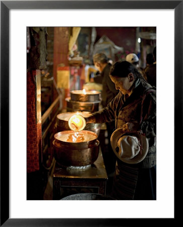 Woman Adding The Melting Yak Butter From Her Lamp To Those Of The Temple, Bharkor, Tibet by Don Smith Pricing Limited Edition Print image
