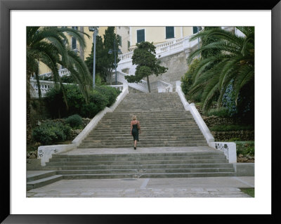 A Woman Climbs Steps In The Old Section Of Mahon, Menorca by Taylor S. Kennedy Pricing Limited Edition Print image