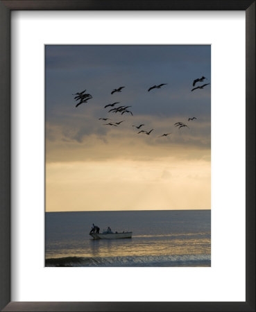 North Carolina Fishermen Cast Nets Under Flock Of Pelicans At Sunset by David Evans Pricing Limited Edition Print image