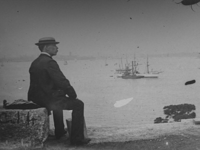 Photographer Wallace G. Levison On Statue Of Liberty Island Looking Out At Boats In Ny Harbor by George B. Brainerd Pricing Limited Edition Print image