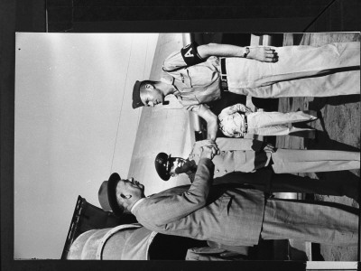 Defense Secretary Neil Mcelroy Shaking Hands With Soldier On Arrival From Enmiwetok At Airport by Ed Clark Pricing Limited Edition Print image