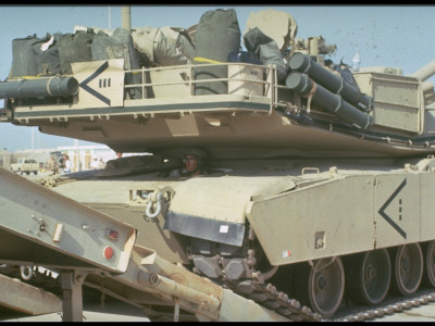 Soldiers Load M-1 Abrams Tank On Flat-Bed Truck, Joining In Desert Shield Gulf Crisis Operation by Gil High Pricing Limited Edition Print image