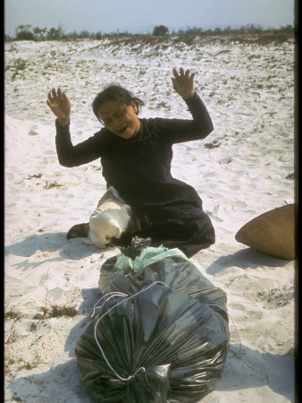 Widow Crying Over Remains Of Husband Recently Found In Mass Grave, Vietnam War Tet Offensive by Larry Burrows Pricing Limited Edition Print image