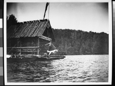 A Boy Watching His Dog Jump Off A Pier Into Lake Hopatkong by Wallace G. Levison Pricing Limited Edition Print image