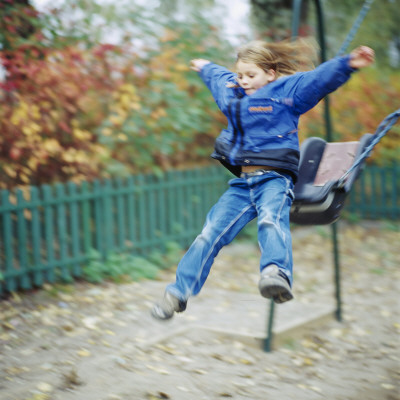 A Girl Jumping From A Swing In A Playground by Niclas Albinsson Pricing Limited Edition Print image