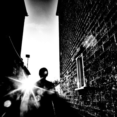 Man In Alley With Low Sun by Phil Sharp Pricing Limited Edition Print image