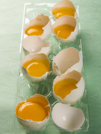 Cracked Eggs In Clear Container Against Green by Brad Wenner Pricing Limited Edition Print image