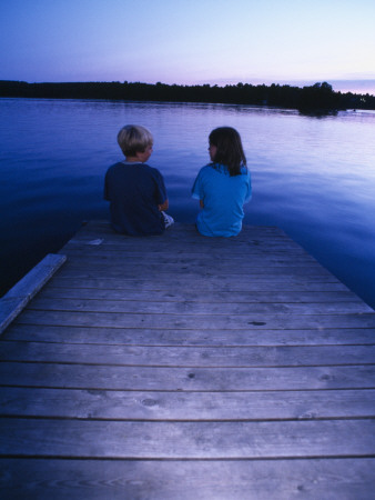Two Children Sitting On A Dock By A Lake, Sweden by Anders Ekholm Pricing Limited Edition Print image