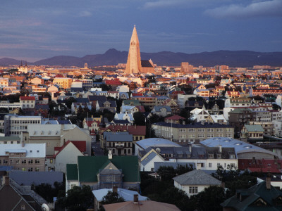 Overview Of Reykjavik, Sun Shining Down On Hallgrimskirkja by Arnaldur Halldorsson Pricing Limited Edition Print image