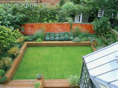 Overview Of Garden With Conservatory, Lawn Edged With Raised Brick Bed Of Box Balls And Grasses by Clive Nichols Pricing Limited Edition Print image