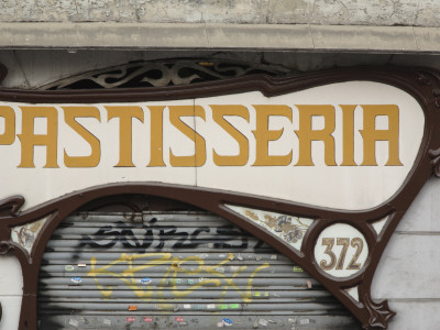 Modernista Facade Of Forn Sarret Bakery - Patisseria With Shutters And Graffiti, Barcelona, Spain by David Borland Pricing Limited Edition Print image