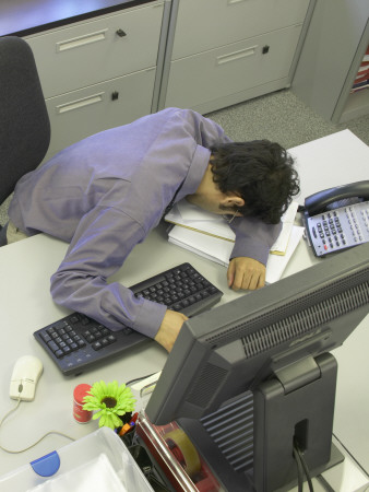 Office Life And Interiors, Office Worker Slumped On Desk by Richard Bryant Pricing Limited Edition Print image