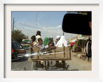Afghans Sit In The Back Of A Cart On The Outskirt Of Kabul, Afghanistan, September 28, 2006 by Musadeq Sadeq Pricing Limited Edition Print image