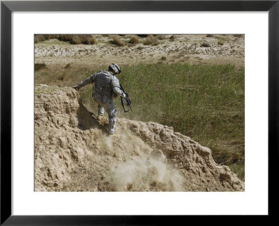Us Army Specialist Climbs Down To The Bottom Of A Canal During A Foot Patrol In Iraq by Stocktrek Images Pricing Limited Edition Print image