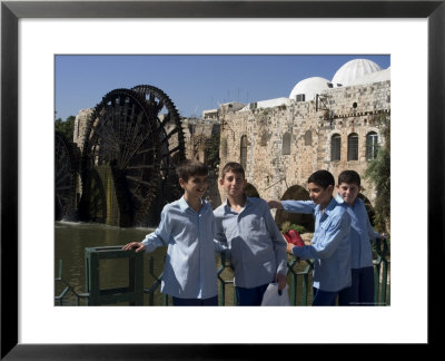 School Boys, In Front Of A Mosque And Water Wheel On The Orontes River, Hama, Syria, Middle East by Christian Kober Pricing Limited Edition Print image
