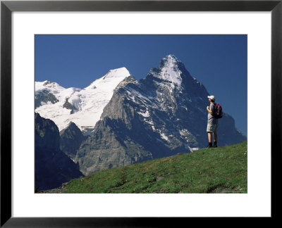 Hiker Looking To The Snow-Covered Monch And The North Face Of The Eiger, Swiss Alps, Switzerland by Ruth Tomlinson Pricing Limited Edition Print image