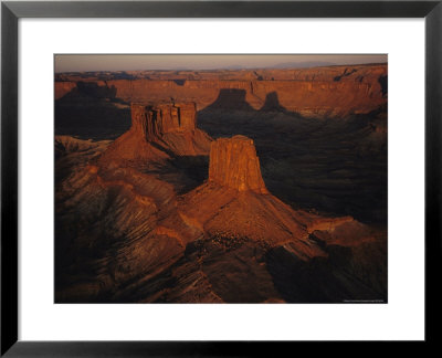 Dawn Over The Buttes Of The Cross And Their Shadows On Rock Cliffs by Melissa Farlow Pricing Limited Edition Print image
