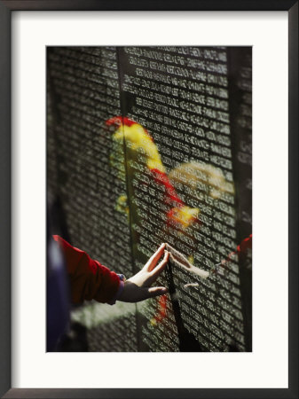 A Hand Reaches Out To Touch A Name On The Vietnam Wall by Steve Raymer Pricing Limited Edition Print image