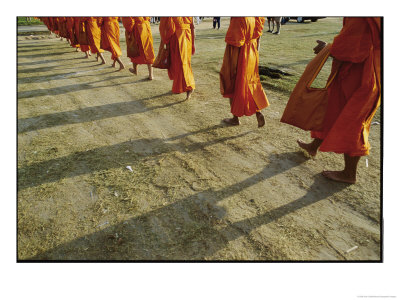 Buddhist Monks Walk Single File Down A Dirt Road by Jodi Cobb Pricing Limited Edition Print image