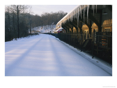 A Pristine Blanket Of Snow Covers An Empty Train Station by Nick Caloyianis Pricing Limited Edition Print image