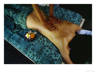 A Woman Receives A Traditional Balinese Oil Massage; A Bowl Of Tropical Flowers Sits Nearby by Eightfish Pricing Limited Edition Print image