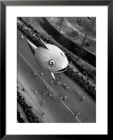 Looking Down Onto Fish Balloon And Crowds Lining Street During Macy's Thanksgiving Day Parade by John Phillips Pricing Limited Edition Print image