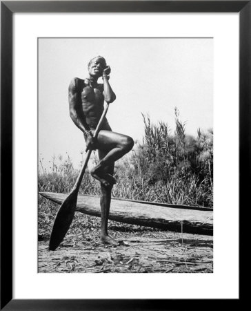 Nuer Tribesman Standing Like A Stork Next To His Canoe In A Papyrus Swamp by Eliot Elisofon Pricing Limited Edition Print image