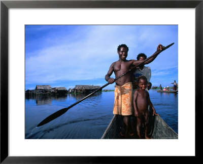 Local Sepik River Family In Dugout Canoe, Madang, Papua New Guinea by Michael Gebicki Pricing Limited Edition Print image