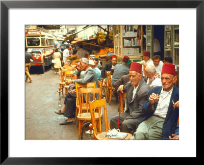 Lebanese Gentlemen Sits At A Steetside Cafe Sipping Tea And Smoking Traditional Narghile Pipes by Carlo Bavagnoli Pricing Limited Edition Print image