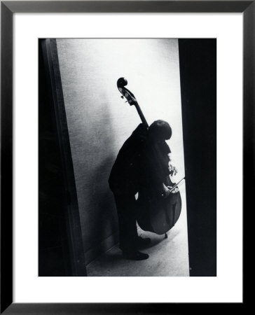 Young Bassist Member Of Alexander Schneider's New York String Orchestra Tuning His Instrument by Gjon Mili Pricing Limited Edition Print image