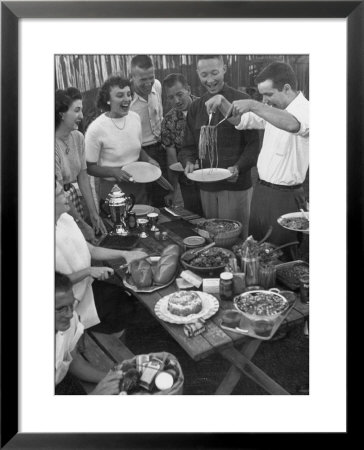 Young Married Couples Enjoying A Backyard Buffet Feast , Featuring Spaghetti by Nina Leen Pricing Limited Edition Print image