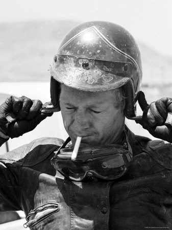 Actor Steve Mcqueen Smoking, Putting On Helmet During 500 Mi. Motorbike Race Across Mojave Desert by John Dominis Pricing Limited Edition Print image
