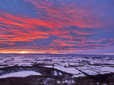 Fiery Sunset Over A Snow Covered Gormire Lake From Sutton Bank On The Edge Of The North Yorkshire M by Lizzie Shepherd Pricing Limited Edition Print image