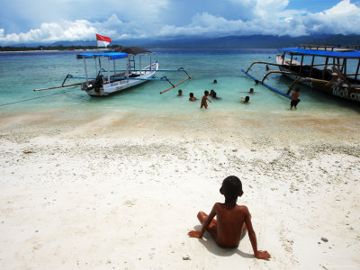 Children Playing In The Sea Next To A 'Glass Bottom Boat by Andrew Brownbill Pricing Limited Edition Print image