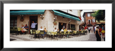 Tourists Sitting At A Sidewalk Cafe, Malcesine, Italy by Panoramic Images Pricing Limited Edition Print image