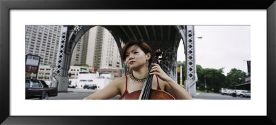 Young Woman Playing A Cello, New York City, Nyc, New York State, Usa by Panoramic Images Pricing Limited Edition Print image