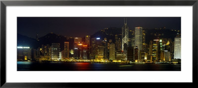 Buildings Lit Up At Night, Hong Kong, China by Panoramic Images Pricing Limited Edition Print image
