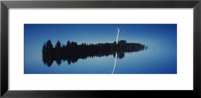 Reflection Of A Wind Turbine And Trees On Water, Black Forest, Germany by Panoramic Images Pricing Limited Edition Print image