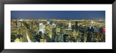 Aerial View Of Buildings Lit Up At Dusk, Manhattan, New York City, New York State, Usa by Panoramic Images Pricing Limited Edition Print image