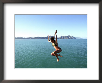 Woman Jumping Off Tolaga Bay Wharf, New Zealand by Oliver Strewe Pricing Limited Edition Print image