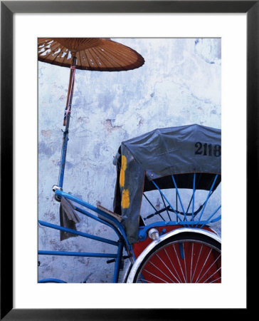 Detail Of Rickshaw Leaning Against Wall On Cintra Street, Georgetown, Malaysia by Tom Cockrem Pricing Limited Edition Print image