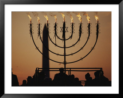 Silhouetted Worshippers Stand Before A Large Menorah Near The Washington Monument by Sam Kittner Pricing Limited Edition Print image