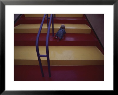 A Young Child Crawls Up Brightly Colored Stairs by Jodi Cobb Pricing Limited Edition Print image