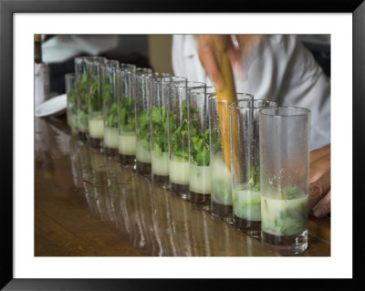 Row Of Glasses On A Bar With Barman Preparing Mojito Cocktails, Habana Vieja, Havana, Cuba by Eitan Simanor Pricing Limited Edition Print image