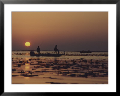 Fishermen Take In The First Rays Of The Rising Sun On Lake Okeechobee by Nicole Duplaix Pricing Limited Edition Print image