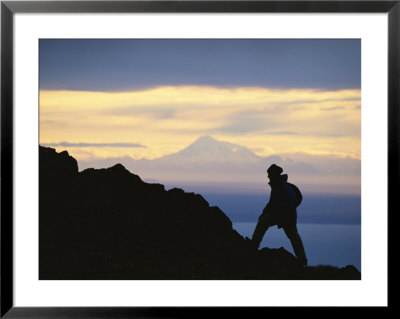 Silhouette Of Hiker Ascending Flat Top Mountain At Sunset by Michael Melford Pricing Limited Edition Print image