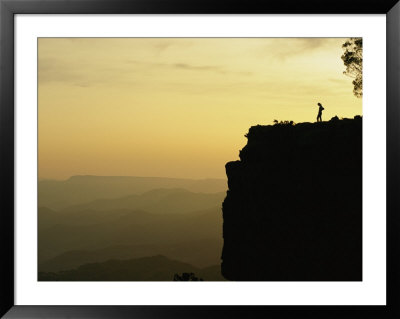 A Climber Stands Silhouetted On A Cliff In South Africa by Bill Hatcher Pricing Limited Edition Print image