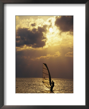 A Windsurfer Skims The Water, Silhouetted By Evening Sun On Pamlico Sound by Stephen St. John Pricing Limited Edition Print image