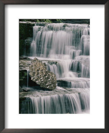 A Time Exposure Captures The Waters Motion As It Falls Over Sculpted Rocks by Skip Brown Pricing Limited Edition Print image